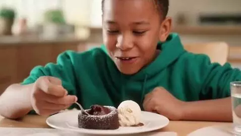 AI Video from prompt: A 10 year old boy eating a Molten lava