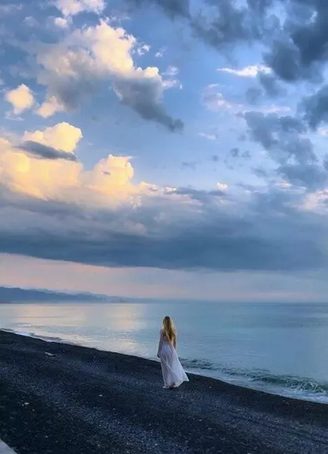 AI Video from prompt: A girl looks at the sunset and her light dress f