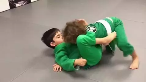 AI Video from prompt: two boys at six years,wearing green bjj jackets,