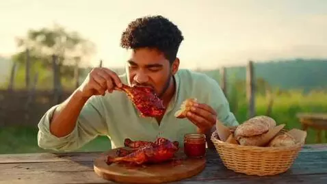 AI Video from prompt: A hungry young man sitting at a rustic outdoor t