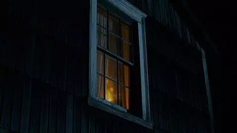 AI Video from prompt: Window of a dark house with flickering light ins