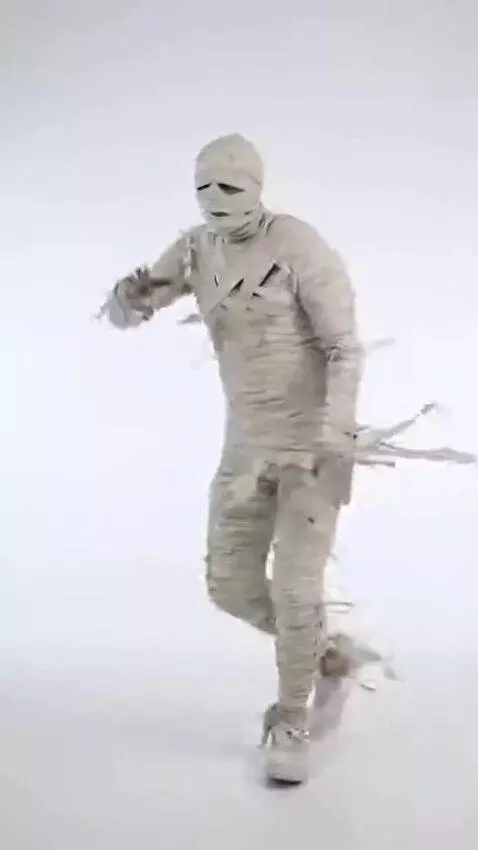 AI Video from prompt: A goofy mummy dancing confidently on a bright wh