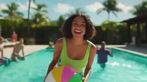 AI Video from prompt: a bikini model at in pool. she picks up a beach 