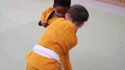 AI Video from prompt: two boys at six years,wearing ochre bjj jackets,