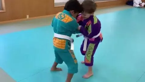 AI Video from prompt: Two boys at six years,wearing colorful bjj-jacke