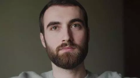 AI Video from prompt: make a man with a beard make him blink multiple 