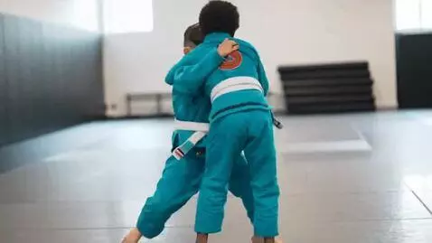 AI Video from prompt: two boys at six years,wearing turquoise bjj jack