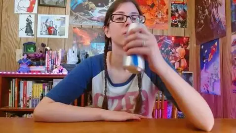 AI Video from prompt: Girl picks up and drinks a can of soda
