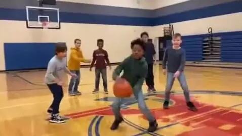 AI Video from prompt: BOYS 9 wearing jeans playing basketball at ymca
