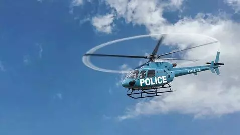 AI Video from prompt: A blue helicopter flies towards the camera and s