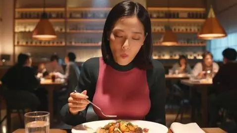 AI Video from prompt: a slim 21 year old woman eating at a restaurant.