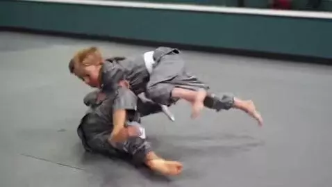 AI Video from prompt: two boys at six years,wearing metallic bjj jacke