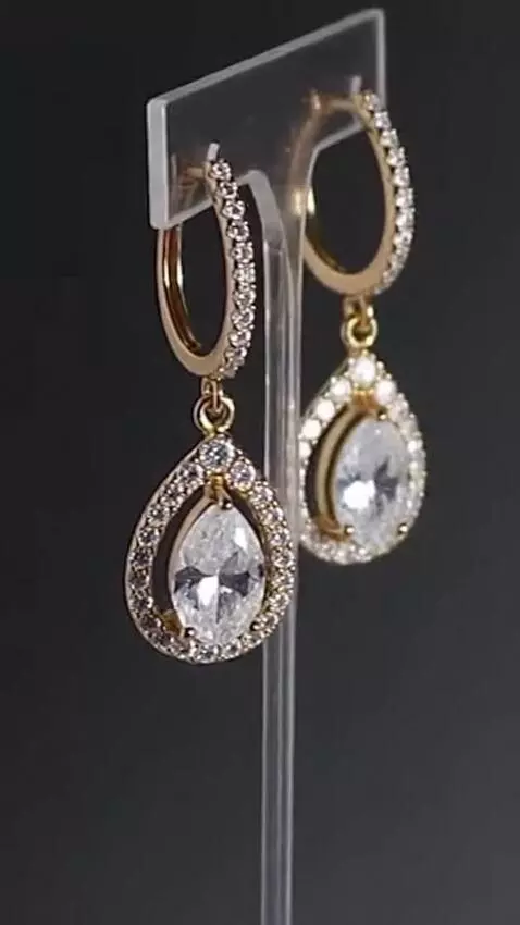 AI Video from prompt: Slow motion close-up of earrings sparkling under