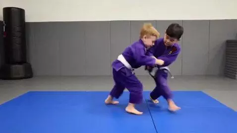 AI Video from prompt: two boys at six years,wearing aubergine bjj jack