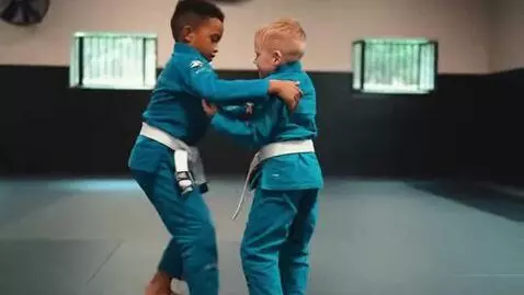 AI Video from prompt: two boys at six years,wearing teal bjj jackets,w