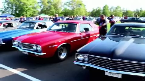 AI Video from prompt: A lineup of 1964-1972 muscle cars getting ready 