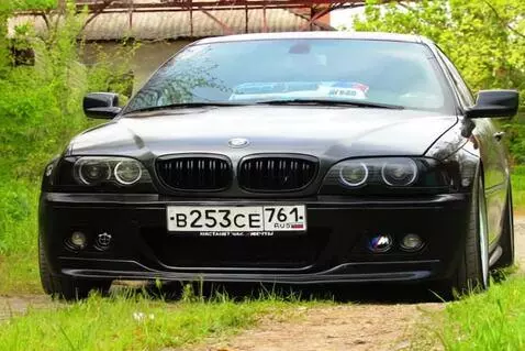 AI Video from prompt: Cinematic low-angle shot of a black BMW E46 seda