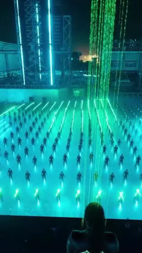 AI Video from prompt: Massive futuristic drum and bass festival at nig
