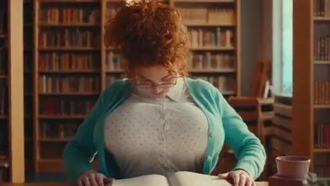 AI Video from prompt: a nerdy woman in a library. she is reading a boo