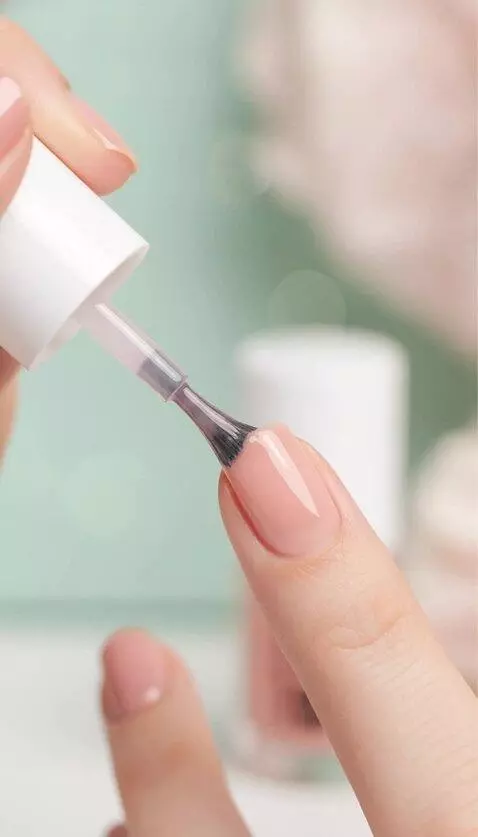 AI Video from prompt: She paints her nails with a translucent, shiny p