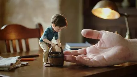 AI Video from prompt: tiny human boy, only 5 cm tall, standing on a wo