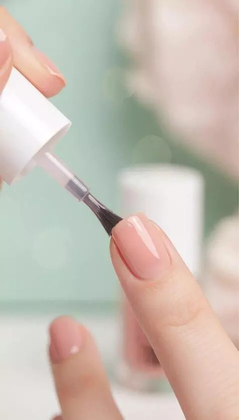 AI Video from prompt: carefully paints the nail with a transparent, sh