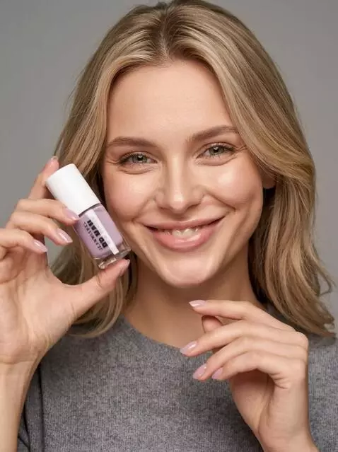 AI Video from prompt: The girl shows off her nail polish and smiles