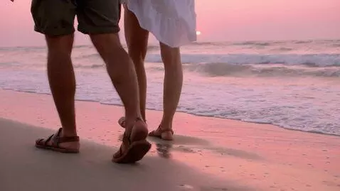AI Video from prompt: A man in shorts and sandals and a woman in a whi
