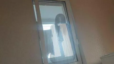 AI Video from prompt: A scary ghost woman appears from behind the balc