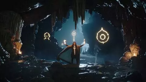 AI Video from prompt: Wide shot inside a cave with stalactites. Flicke
