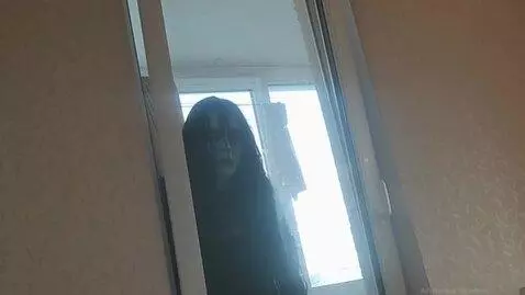 AI Video from prompt: A scary dead woman with terrible eyes appears ou