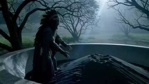 AI Video from prompt: The shaman slowly raises his hands, and the sand