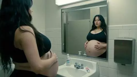 AI Video from prompt: An extremely bloated American woman looks in a m