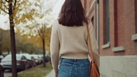 AI Video from prompt: Woman walking away wearing jeans