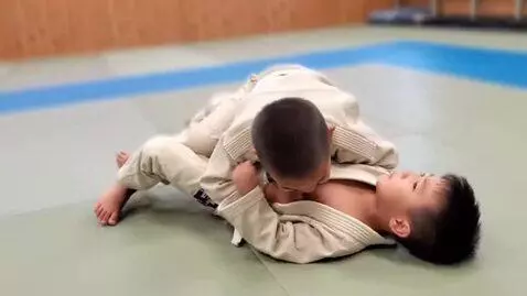 AI Video from prompt: two boys at six years,wearing beige bjj jackets,