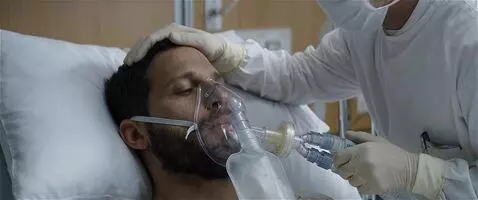 AI Video from prompt: The patient breathes into his oxygen mask as the