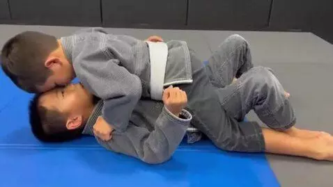 AI Video from prompt: two boys at six years,wearing gray bjj jackets,w