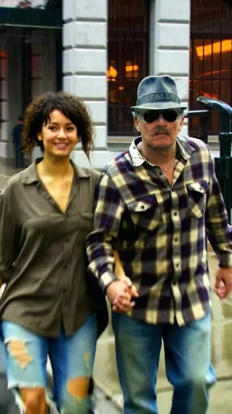 AI Video from prompt: A man in a hat, in an equal shirt and jeans, hol