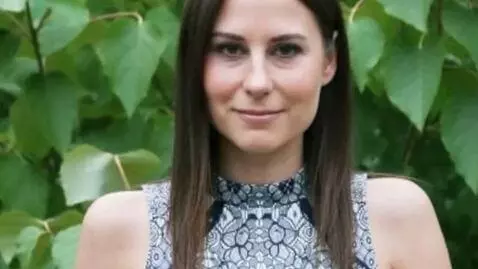 AI Video from prompt: Make woman give cute look, as she is standing st