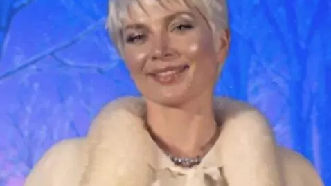 AI Video from prompt: a charming fifty-year-old snow queen with a silv