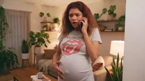 AI Video from prompt: An American woman is talking on the phone and wa