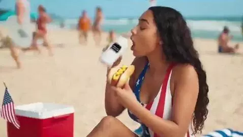 AI Video from prompt: A beach party. A 20 year old woman in an America