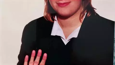 AI Video from prompt: my future wife, waving and smiling at me .