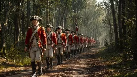 AI Video from prompt: Cinematic tracking shot. A column of British Red