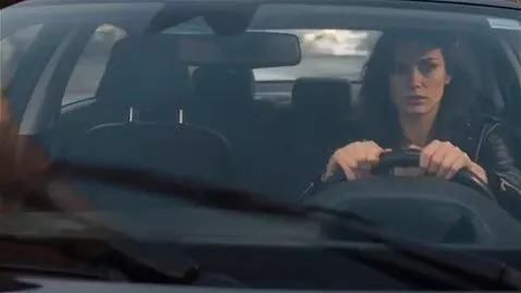AI Video from prompt: A woman is driving through the city