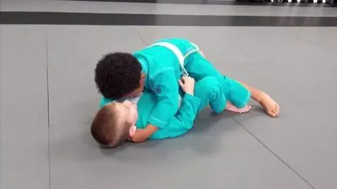 AI Video from prompt: two boys at six years,wearing torquise bjj jacke