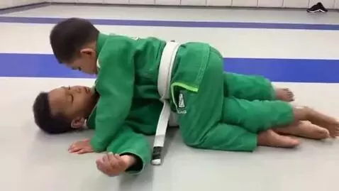 AI Video from prompt: two boys at six years,wearing green bjj jackets,