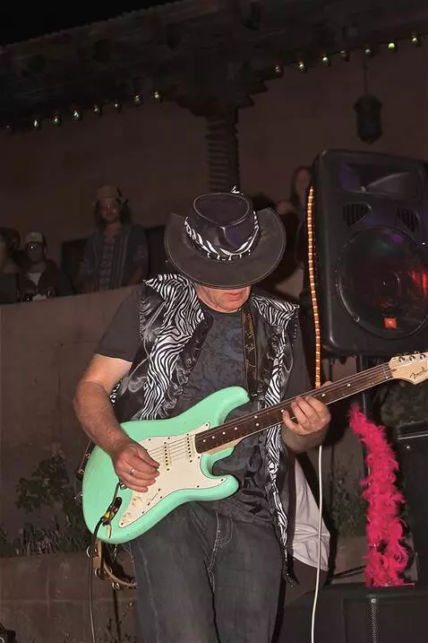 AI Video from prompt: the guitarist plays blistering lead guitar wowin