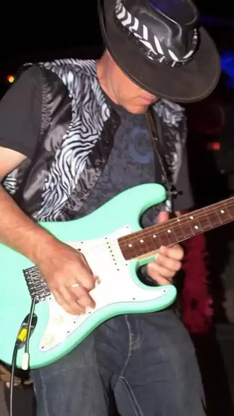 AI Video from prompt: the guitarist plays blistering lead guitar wowin