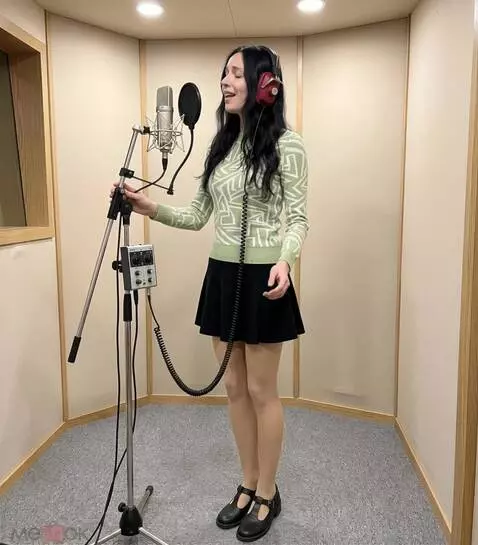 AI Video from prompt: A woman sings while holding headphones to her he